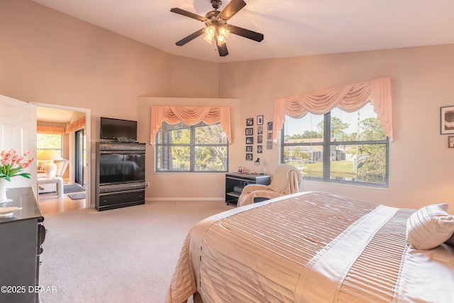 carpeted bedroom with ceiling fan and lofted ceiling