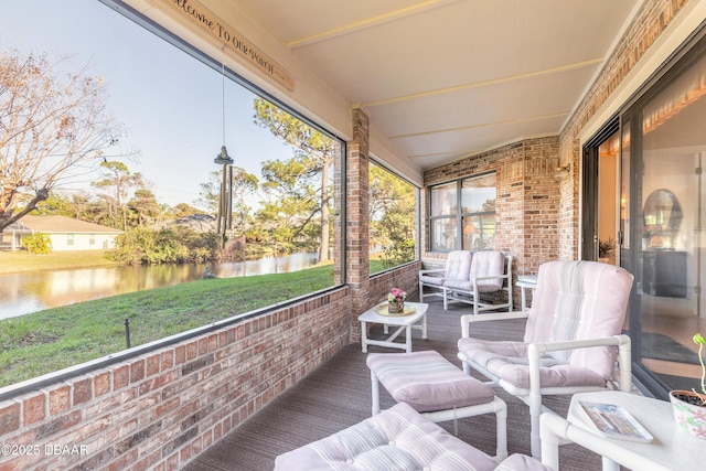 sunroom / solarium with a water view