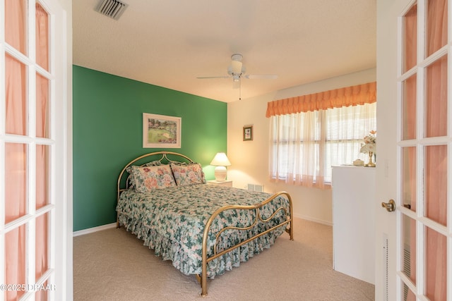 bedroom featuring ceiling fan and light carpet