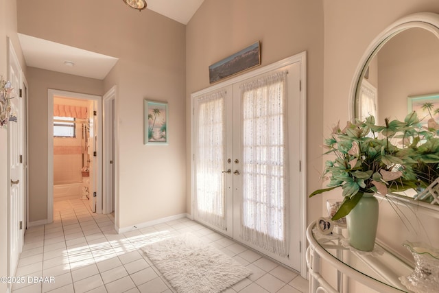 entryway with light tile patterned floors and french doors