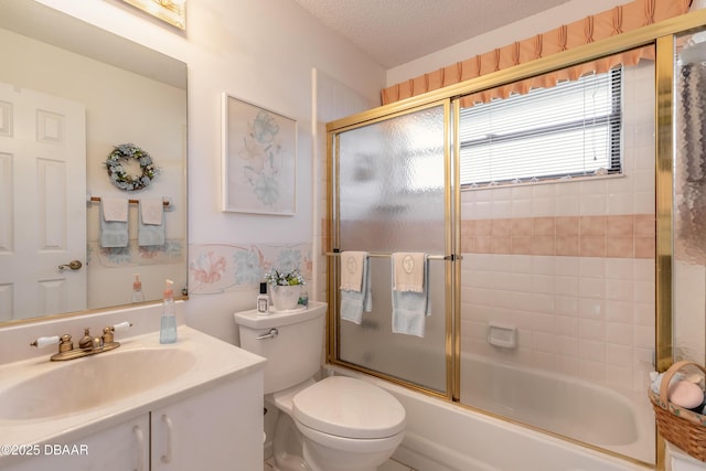 full bathroom featuring a textured ceiling, toilet, vanity, and shower / bath combination with glass door