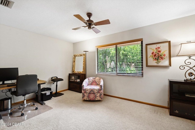 office featuring a textured ceiling, light colored carpet, and ceiling fan