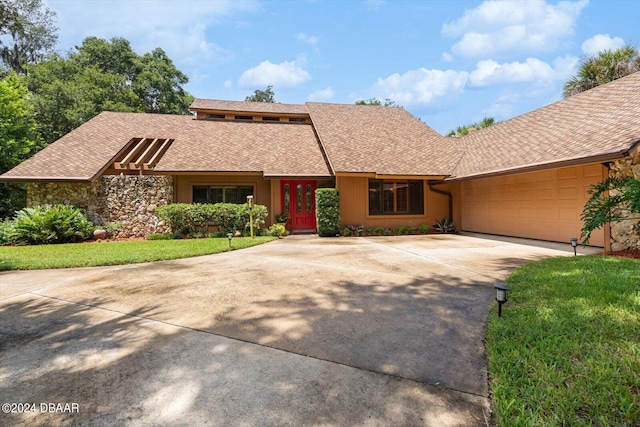 view of front of property with a garage and a front yard