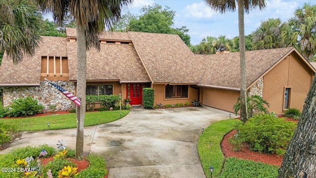 view of front of property with a garage and a front yard