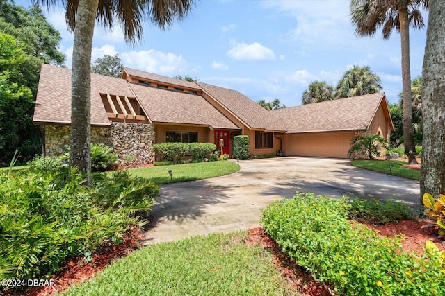 view of front of property with a garage and a front yard