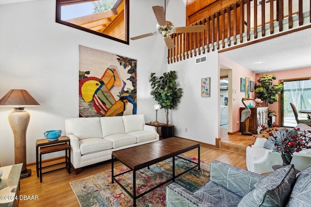 living room featuring high vaulted ceiling, hardwood / wood-style floors, and ceiling fan