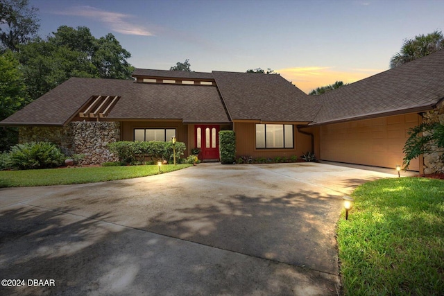 view of front of property with a lawn and a garage