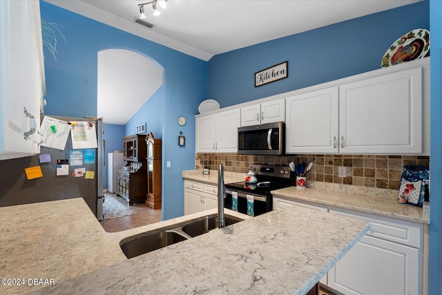 kitchen featuring stainless steel appliances, white cabinets, sink, and decorative backsplash