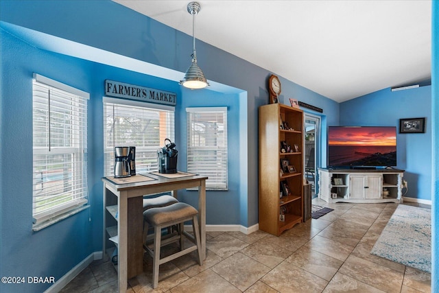 dining space featuring lofted ceiling