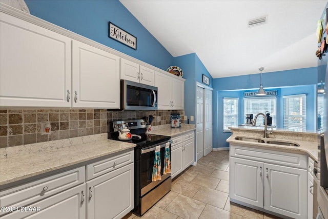 kitchen featuring white cabinets, appliances with stainless steel finishes, lofted ceiling, and sink