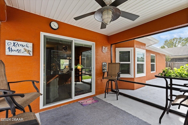 sunroom / solarium featuring ceiling fan