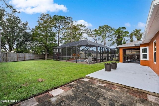 view of yard featuring a lanai and a patio area