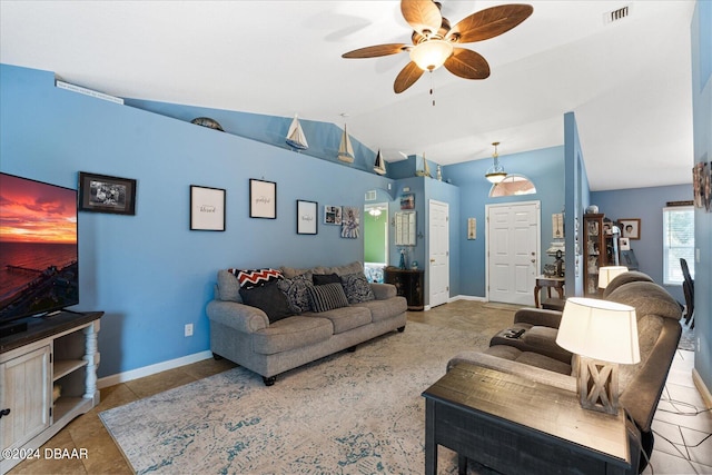 tiled living room with ceiling fan and lofted ceiling