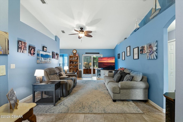 tiled living room with ceiling fan and vaulted ceiling