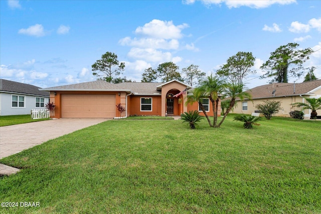 ranch-style home featuring a garage and a front yard