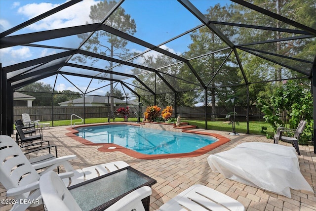 view of pool with a lanai, a patio, and a yard