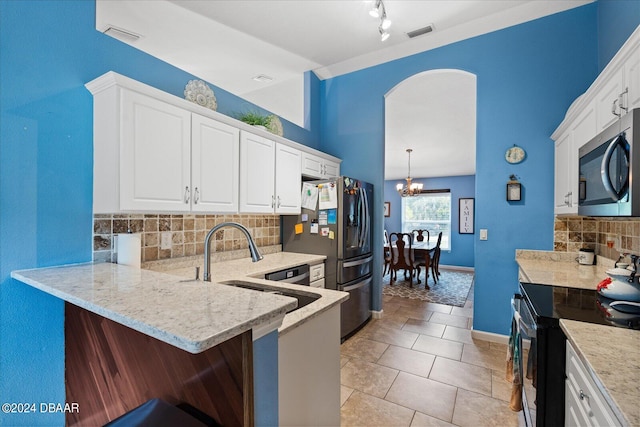 kitchen featuring white cabinets, a kitchen bar, and appliances with stainless steel finishes