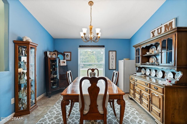 dining area with an inviting chandelier and vaulted ceiling