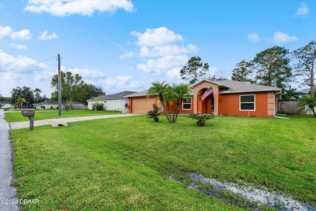 ranch-style house featuring a garage and a front yard