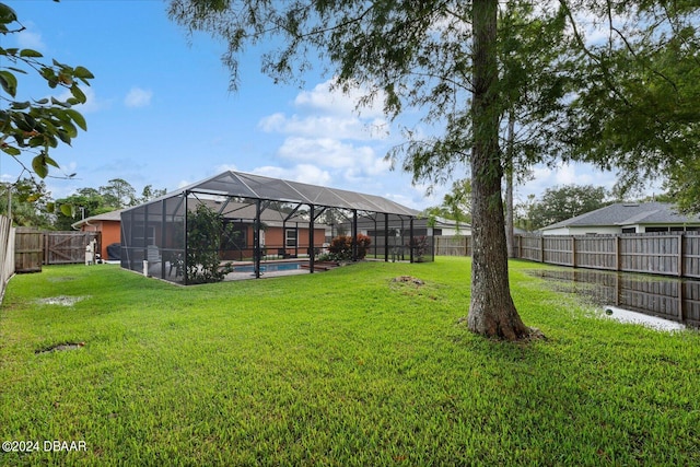 view of yard with a fenced in pool and a lanai