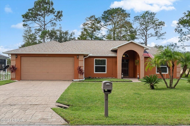 ranch-style house with a garage and a front yard