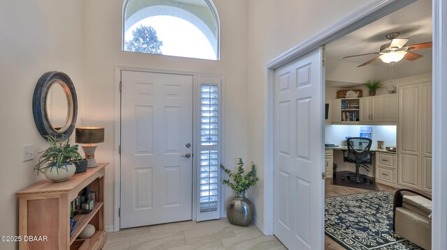 1453 Sunningdale Ln, Ormond Beach, FL 32174 - foyer entrance featuring built in study area, a ceiling fan, and baseboards