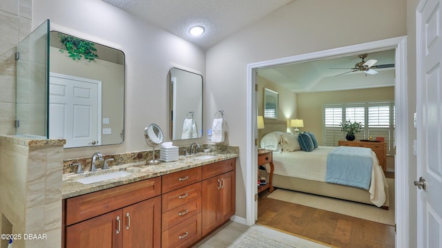 1453 Sunningdale Ln, Ormond Beach, FL 32174 - bathroom with a textured ceiling, ceiling fan, a sink, and ensuite bathroom