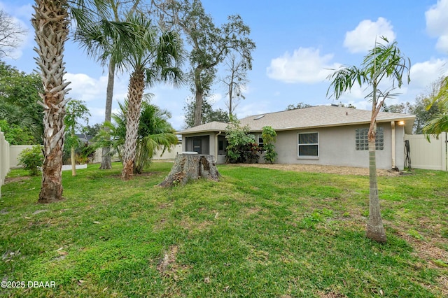 back of house with a lawn