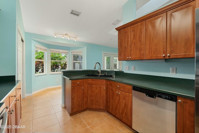 kitchen featuring stainless steel dishwasher, kitchen peninsula, light tile patterned floors, and sink