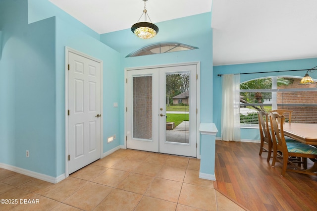 foyer entrance with french doors and light tile patterned floors