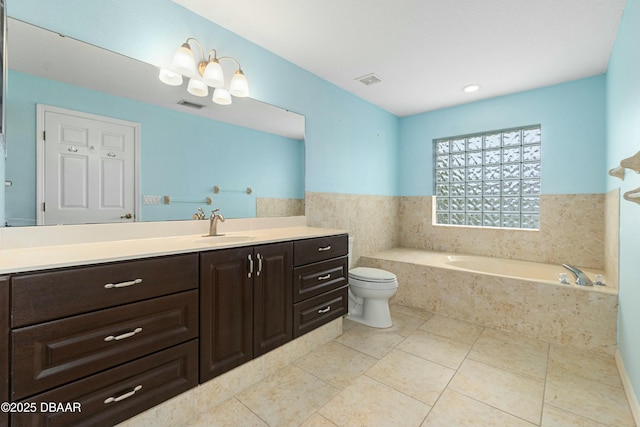 bathroom with tile patterned floors, vanity, tiled bath, and toilet