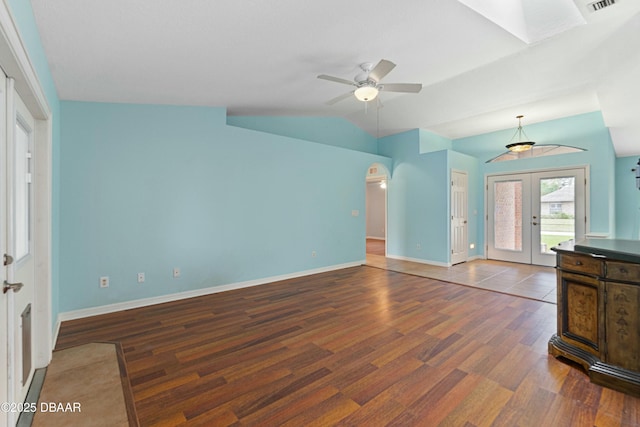 unfurnished living room featuring hardwood / wood-style flooring, ceiling fan, lofted ceiling, and french doors