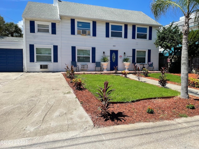 view of front facade featuring a front yard and a garage