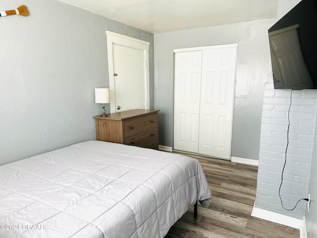 bedroom with a closet and wood-type flooring