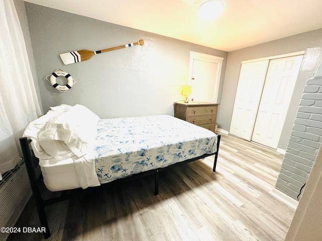 bedroom featuring light hardwood / wood-style flooring and a closet