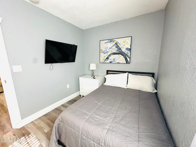 bedroom with hardwood / wood-style flooring