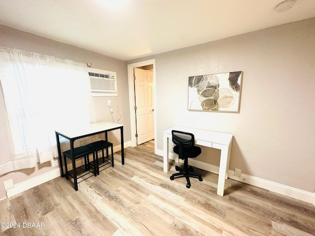 home office with hardwood / wood-style flooring and an AC wall unit