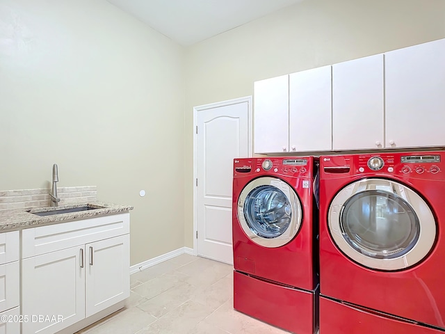 washroom featuring sink, separate washer and dryer, and cabinets