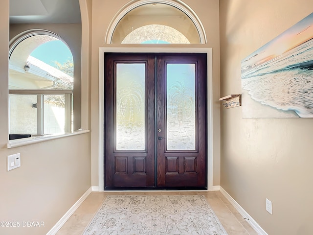 doorway with light tile patterned floors and french doors