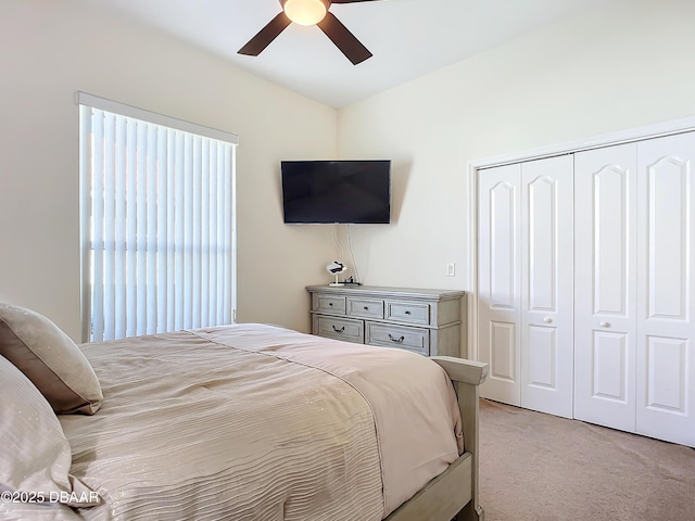 bedroom featuring light carpet, a closet, and ceiling fan