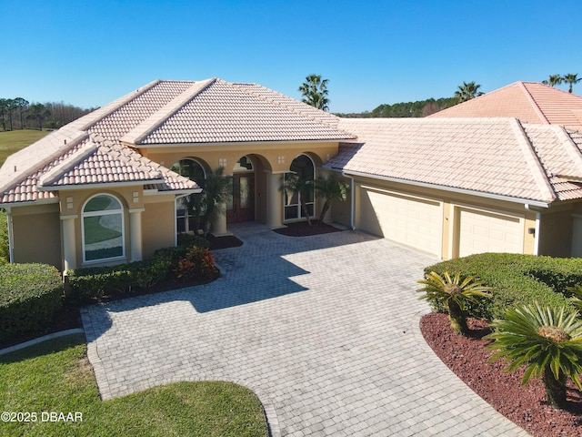 mediterranean / spanish-style home with a garage