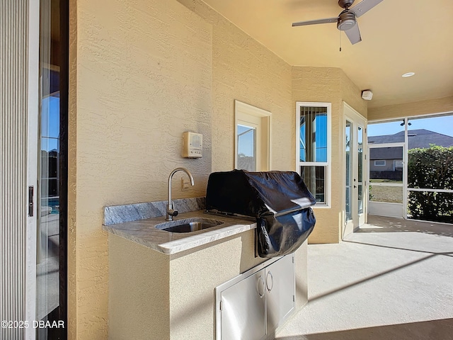 view of patio featuring sink and a grill