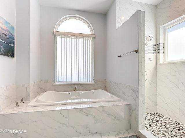 bathroom with separate shower and tub