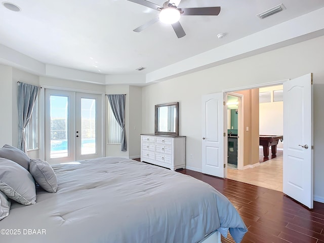 bedroom featuring multiple windows, ceiling fan, and french doors