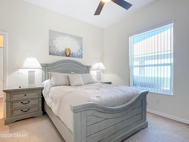 bedroom with ceiling fan and light carpet