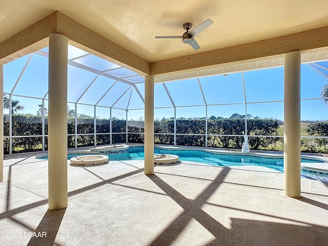 view of swimming pool featuring glass enclosure, an in ground hot tub, and a patio area