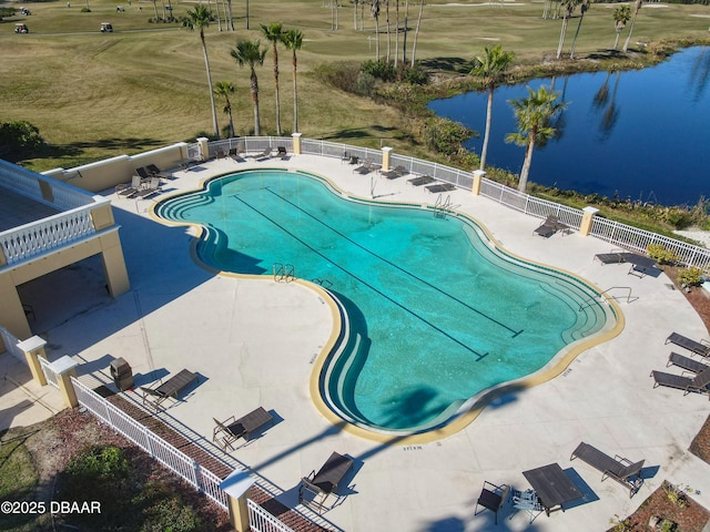 view of pool with a water view and a patio area