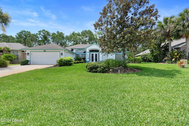 view of front facade featuring french doors, a front lawn, and a garage