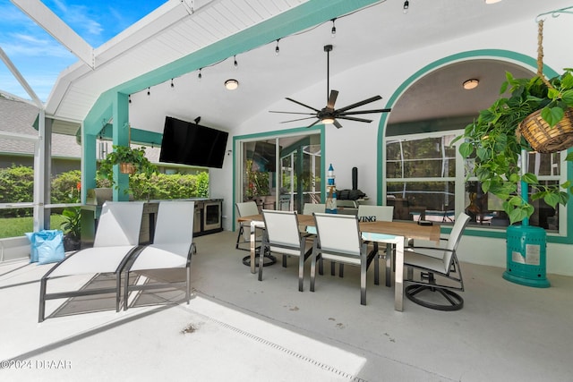 view of patio / terrace featuring ceiling fan and glass enclosure