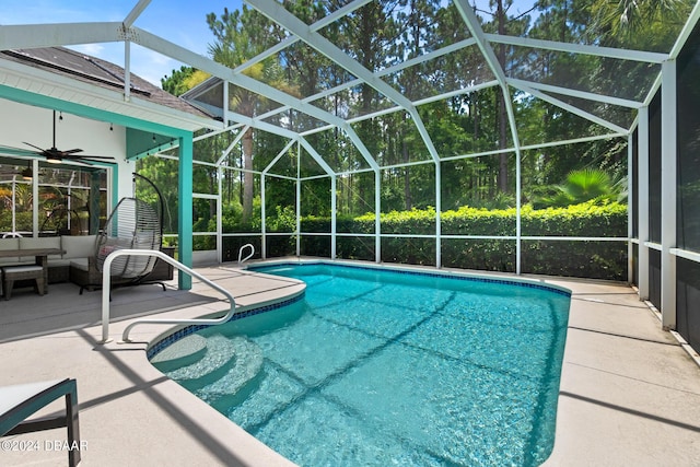 view of swimming pool featuring ceiling fan, a lanai, a patio, and outdoor lounge area